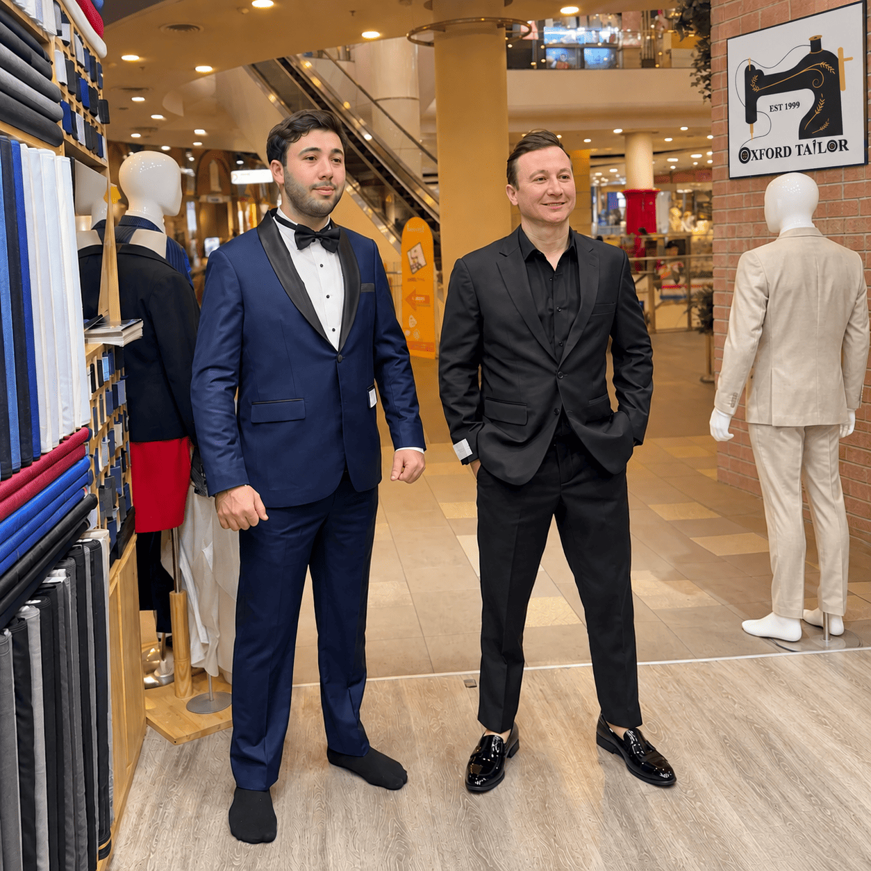 Customers trying on tailored suits at Oxford Tailor